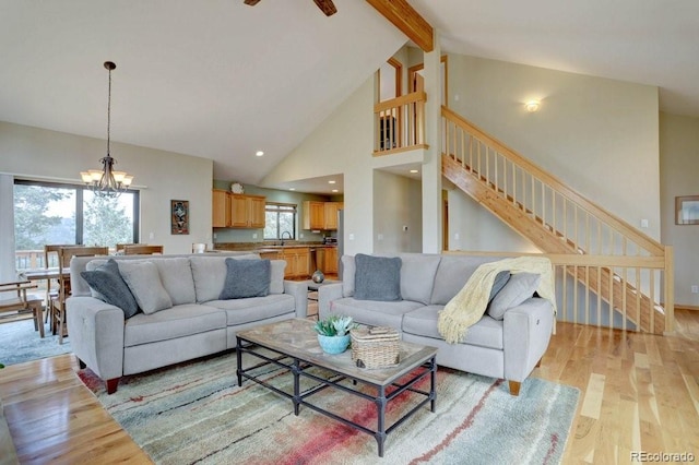 220 Long Ridge Dr, Bailey, CO 80421 - living area with light wood finished floors, beamed ceiling, stairway, a chandelier, and high vaulted ceiling