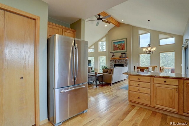 220 Long Ridge Dr, Bailey, CO 80421 - kitchen with freestanding refrigerator, a fireplace, light wood finished floors, a ceiling fan, and high vaulted ceiling