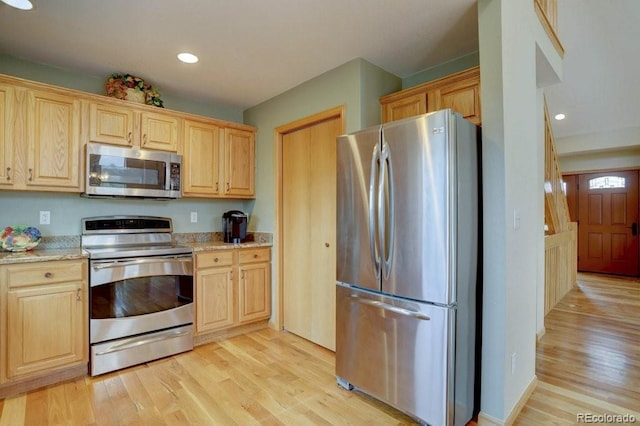 220 Long Ridge Dr, Bailey, CO 80421 - kitchen featuring appliances with stainless steel finishes, light brown cabinetry, light wood-type flooring, light stone counters, and recessed lighting