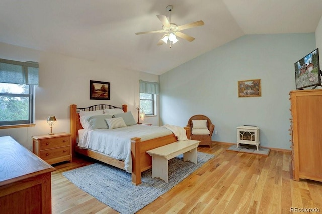 220 Long Ridge Dr, Bailey, CO 80421 - bedroom with a wood stove, vaulted ceiling, light wood finished floors, and a ceiling fan