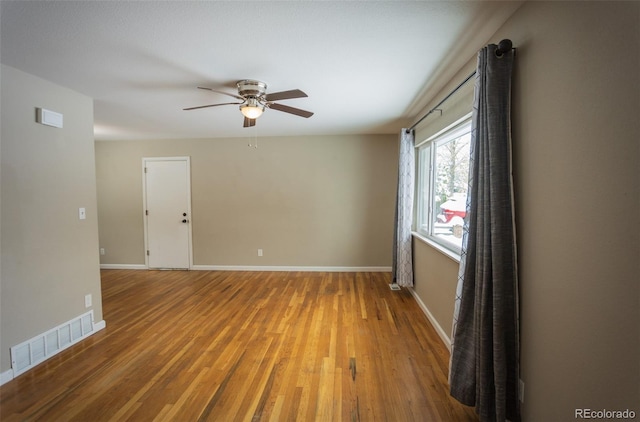 spare room with hardwood / wood-style flooring and ceiling fan