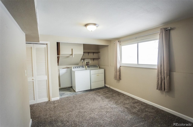 laundry room featuring light colored carpet, a textured ceiling, and washer and dryer