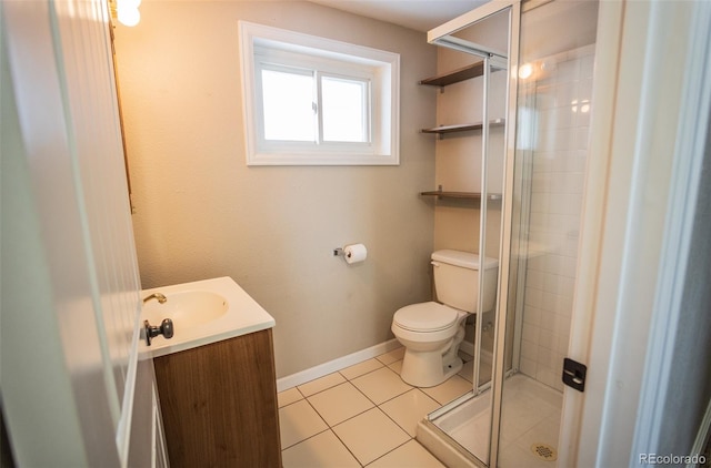 bathroom featuring vanity, tile patterned flooring, toilet, and an enclosed shower