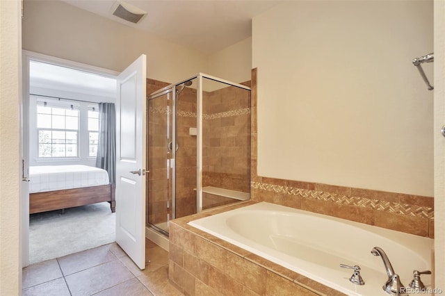 ensuite bathroom featuring a stall shower, a bath, and tile patterned floors