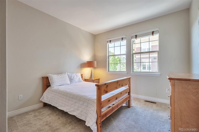 carpeted bedroom featuring baseboards