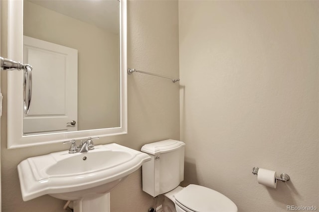 bathroom featuring toilet and a sink