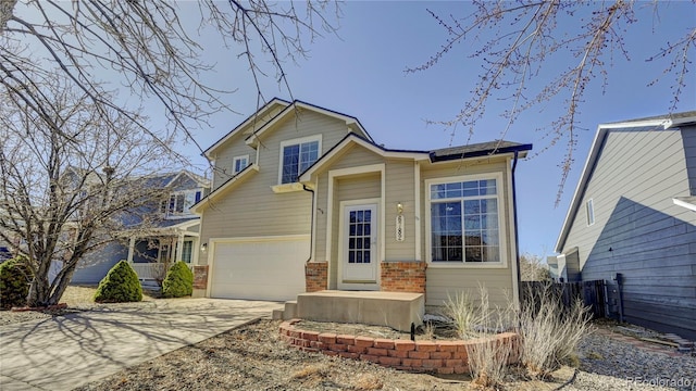 view of front of house with a garage, concrete driveway, and brick siding