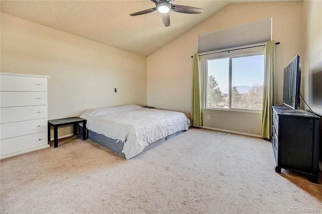 bedroom with lofted ceiling, visible vents, a textured ceiling, and carpet flooring