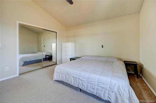 bedroom with a closet, baseboards, vaulted ceiling, and carpet flooring