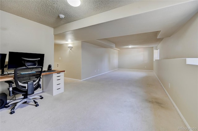 office featuring a textured ceiling, light carpet, and baseboards