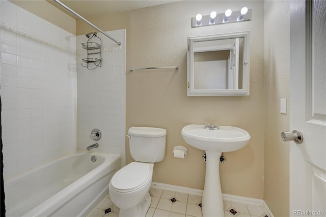 full bathroom with washtub / shower combination, baseboards, toilet, and tile patterned floors