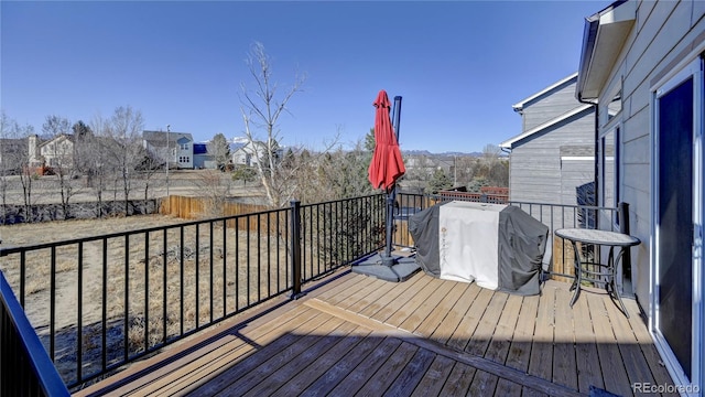 wooden terrace featuring a grill