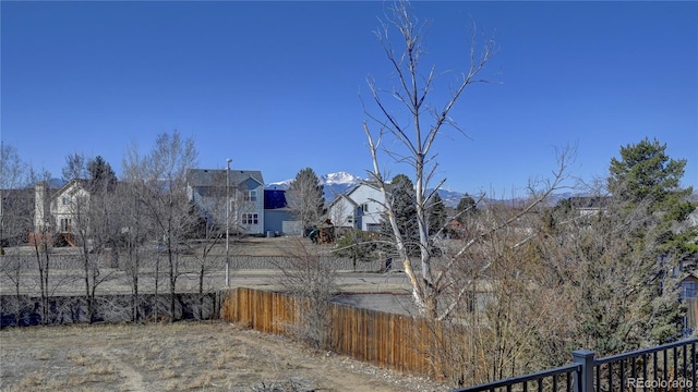 view of yard featuring a residential view and fence