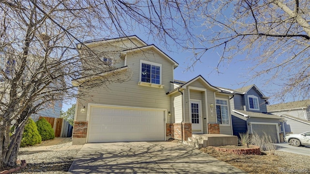 view of front of property featuring a garage, fence, concrete driveway, and brick siding