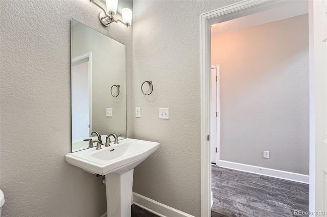 3573 S Lisbon Ct, Aurora, CO 80013 - bathroom featuring wood finished floors, baseboards, and a textured wall