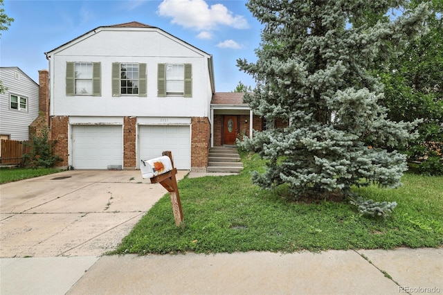 2527 S Ouray Way, Aurora, CO 80013 - tri-level home featuring driveway, an attached garage, and brick siding