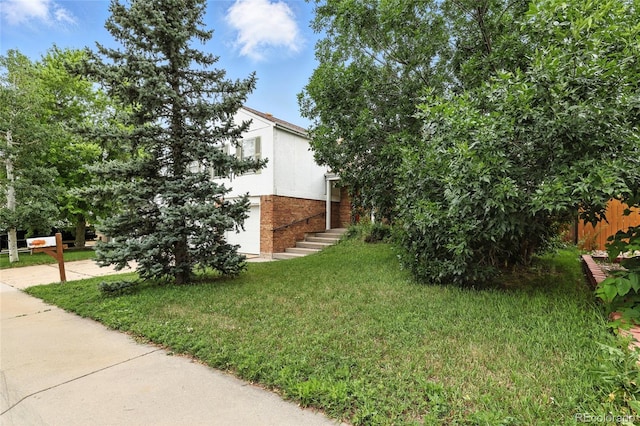 2527 S Ouray Way, Aurora, CO 80013 - view of side of home with brick siding and a yard