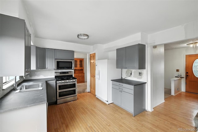 2527 S Ouray Way, Aurora, CO 80013 - kitchen with stainless steel appliances, light wood-style floors, and gray cabinetry
