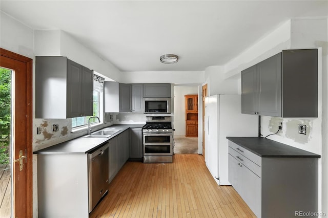 2527 S Ouray Way, Aurora, CO 80013 - kitchen with appliances with stainless steel finishes, gray cabinets, and healthy amount of natural light