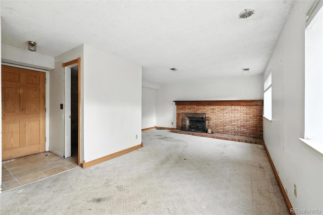 2527 S Ouray Way, Aurora, CO 80013 - unfurnished living room with carpet, a brick fireplace, and a textured ceiling