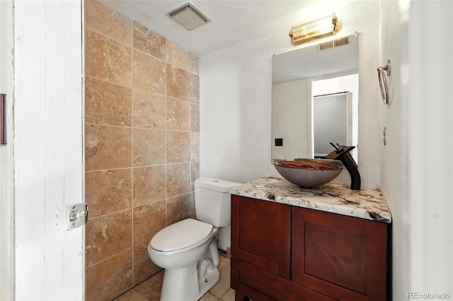 2527 S Ouray Way, Aurora, CO 80013 - bathroom with vanity and tile walls