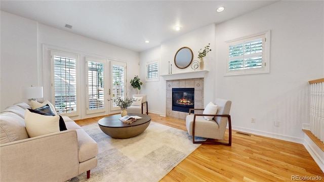 203 S Jackson St, Denver, CO 80209 - living area featuring plenty of natural light, light wood-style floors, a fireplace, and recessed lighting