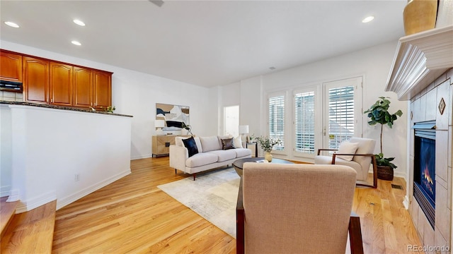 203 S Jackson St, Denver, CO 80209 - living room with a glass covered fireplace, light wood-style floors, and recessed lighting