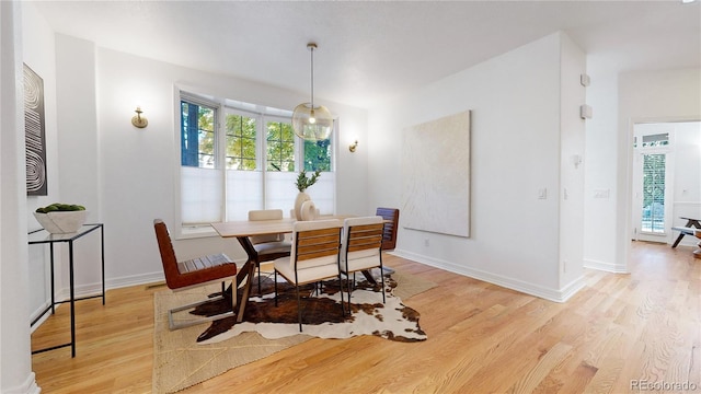 203 S Jackson St, Denver, CO 80209 - dining space featuring light wood-type flooring and baseboards