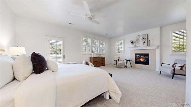 203 S Jackson St, Denver, CO 80209 - carpeted bedroom with a tile fireplace and a ceiling fan