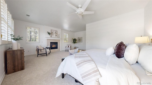 203 S Jackson St, Denver, CO 80209 - bedroom with light carpet, a glass covered fireplace, and a ceiling fan