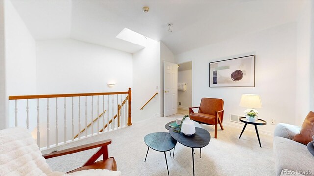 203 S Jackson St, Denver, CO 80209 - sitting room with an upstairs landing, vaulted ceiling, carpet, and a skylight