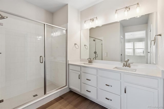 bathroom with vanity, an enclosed shower, and hardwood / wood-style floors