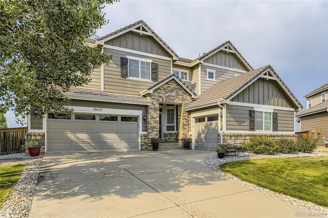 16059 E Grass River Pl, Parker, CO 80134 - craftsman house with board and batten siding, driveway, stone siding, and a tile roof