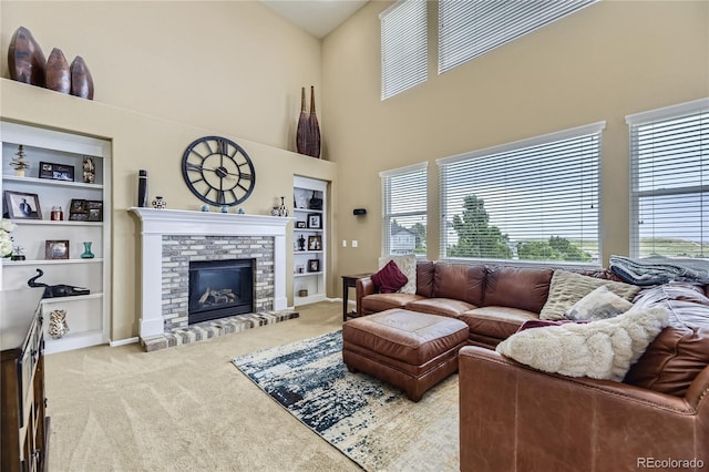 16059 E Grass River Pl, Parker, CO 80134 - living area featuring carpet flooring, plenty of natural light, built in shelves, a brick fireplace, and a towering ceiling