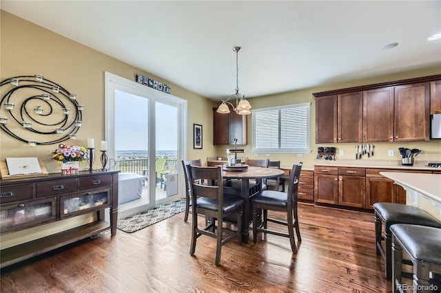 16059 E Grass River Pl, Parker, CO 80134 - dining area with dark wood-style flooring and a chandelier