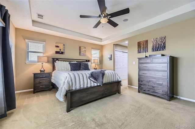 16059 E Grass River Pl, Parker, CO 80134 - bedroom with light colored carpet, a raised ceiling, a ceiling fan, and a closet