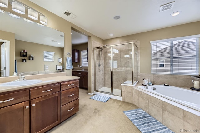 16059 E Grass River Pl, Parker, CO 80134 - bathroom with vanity, a shower stall, a garden tub, and recessed lighting