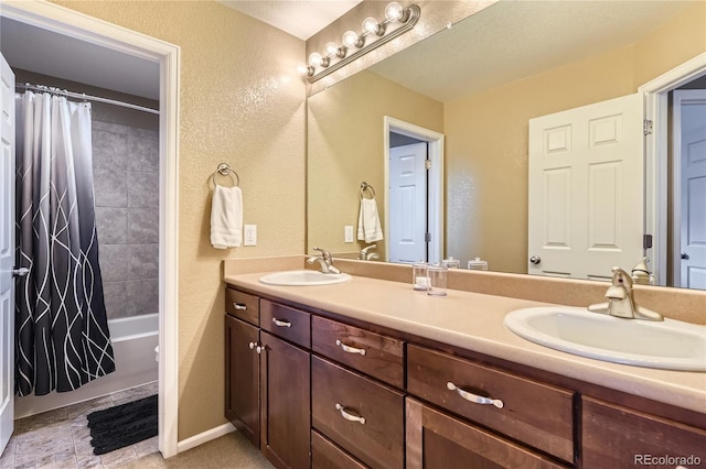 16059 E Grass River Pl, Parker, CO 80134 - bathroom with double vanity, a textured wall, and shower / bath combo