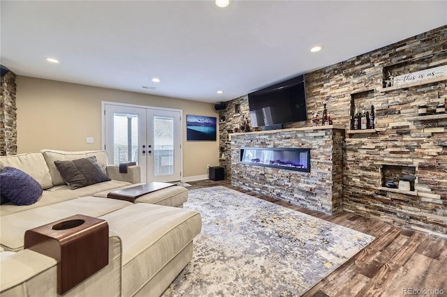 16059 E Grass River Pl, Parker, CO 80134 - living room with french doors, a glass covered fireplace, wood finished floors, and recessed lighting