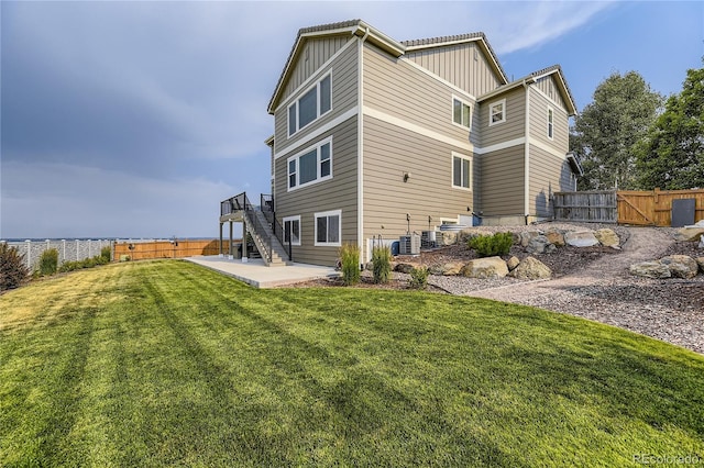 16059 E Grass River Pl, Parker, CO 80134 - back of property with board and batten siding, a patio, a fenced backyard, and stairs