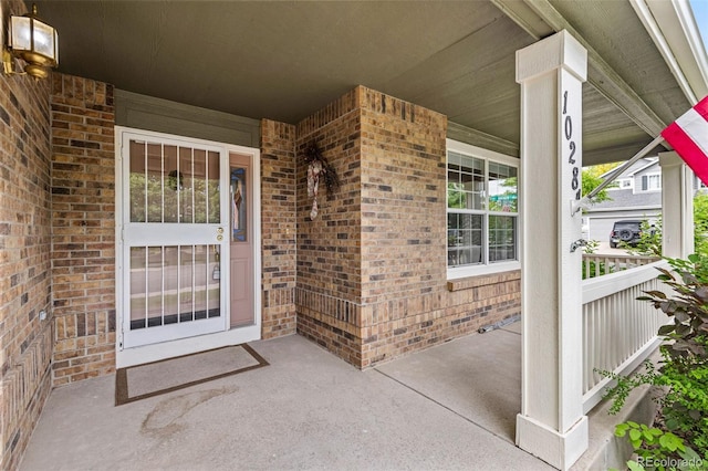 10284 Royal Eagle St, Highlands Ranch, CO 80129 - doorway to property featuring brick siding and covered porch