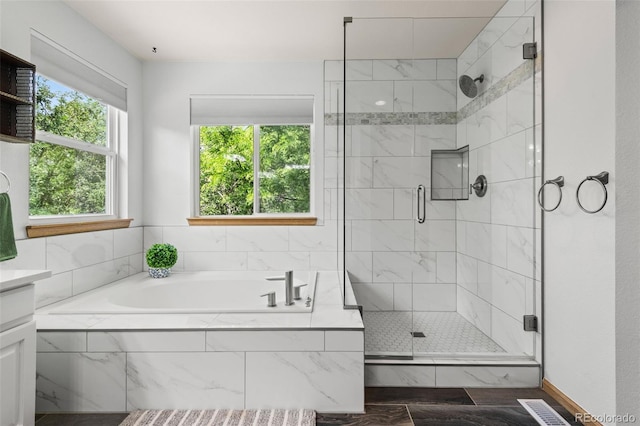 10284 Royal Eagle St, Highlands Ranch, CO 80129 - full bathroom featuring a garden tub, a marble finish shower, and vanity