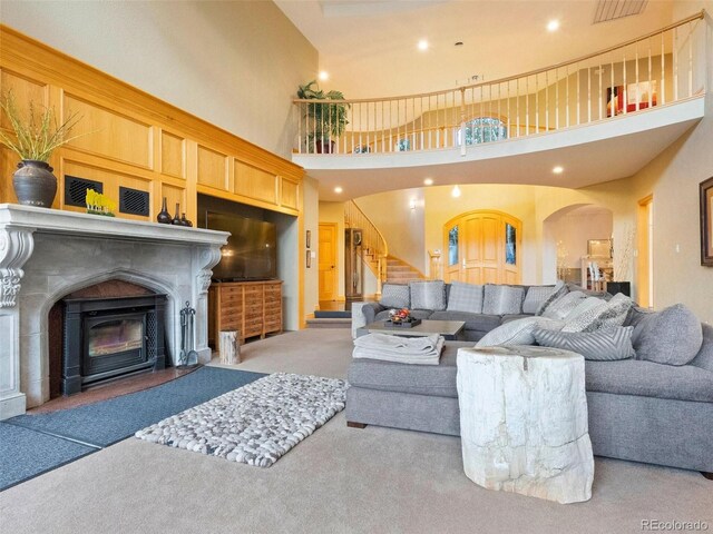 carpeted living room featuring a high ceiling