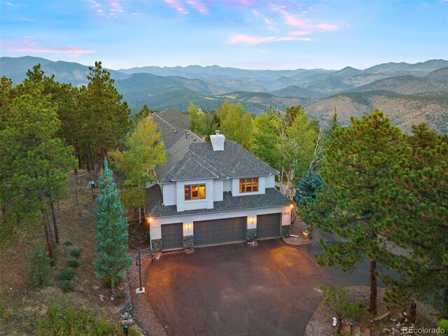 aerial view at dusk featuring a mountain view