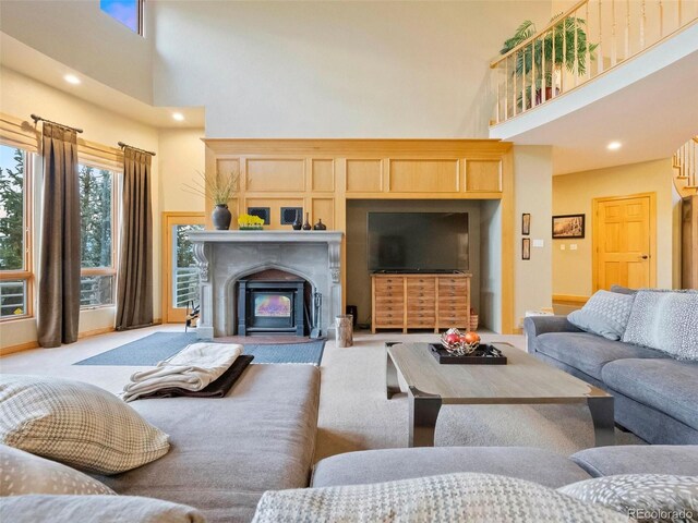 carpeted living room featuring a high ceiling