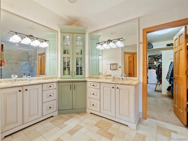 bathroom featuring vanity, an enclosed shower, and tile patterned floors