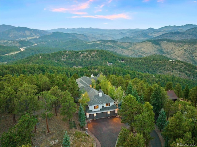 aerial view with a wooded view and a mountain view