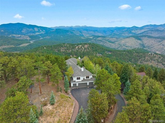 aerial view with a mountain view and a view of trees