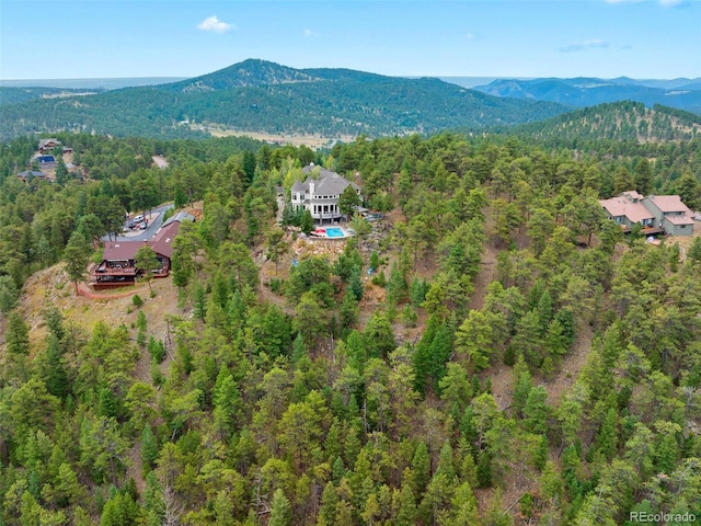 aerial view with a mountain view and a wooded view