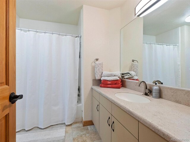 bathroom featuring tile patterned flooring, vanity, and shower / tub combo with curtain